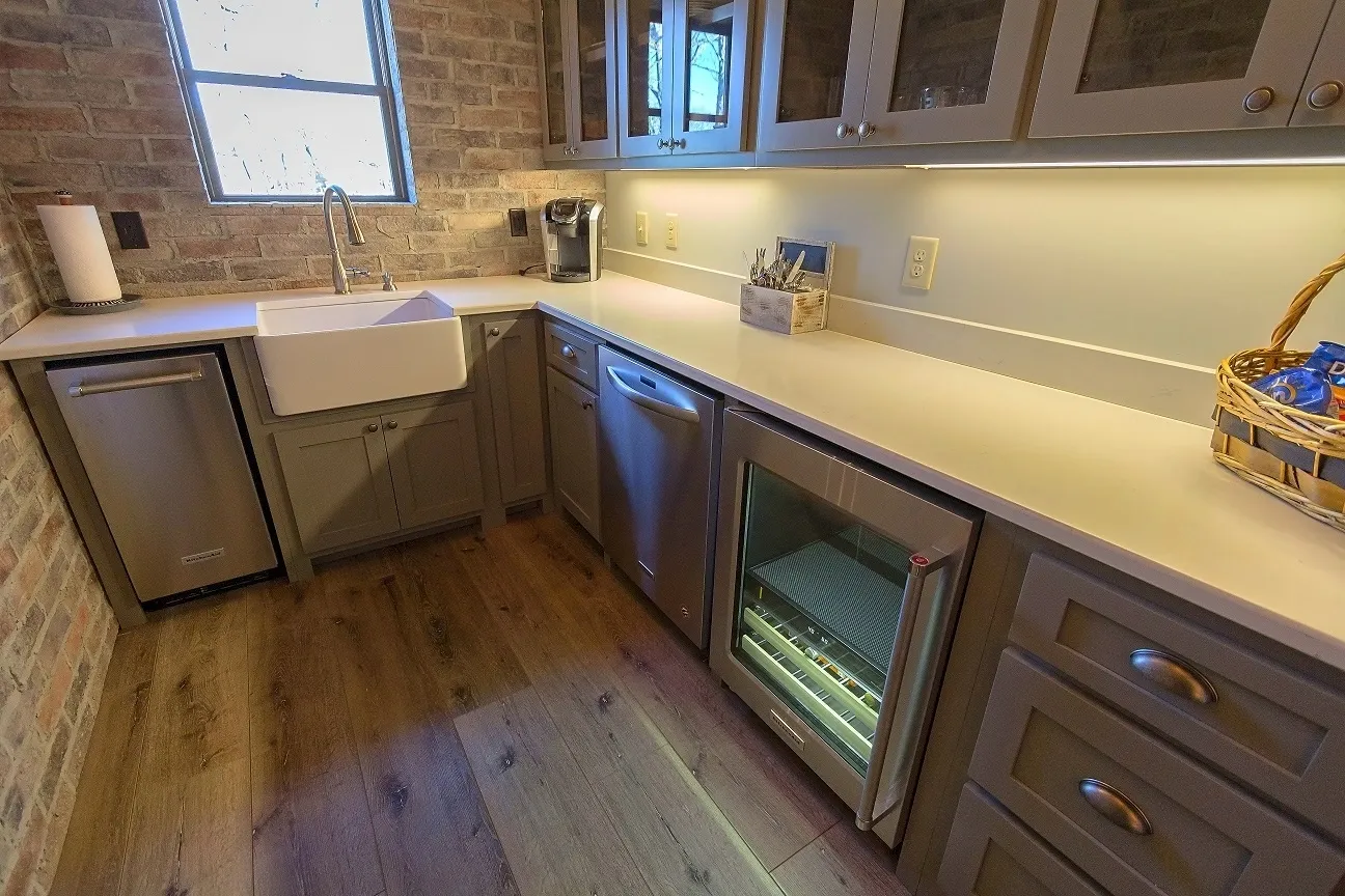 A kitchen with a sink and refrigerator in it