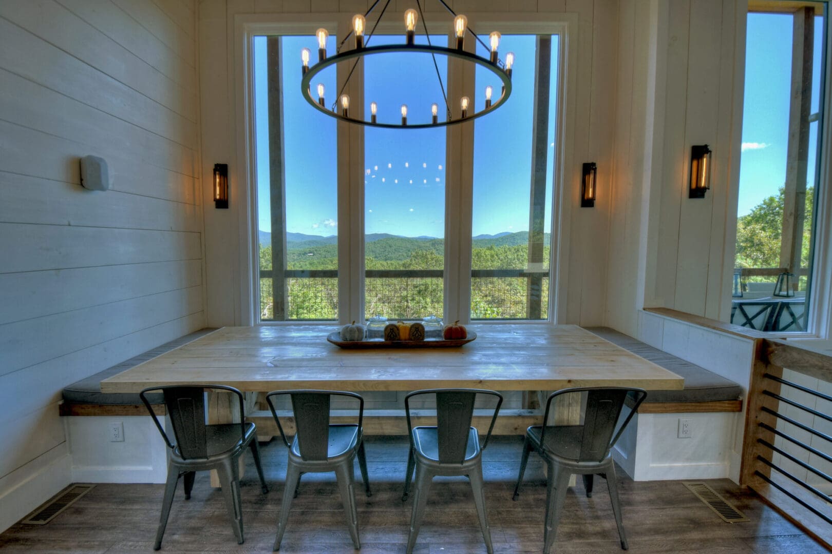 Architectural Design services: A dining room with a table and chairs overlooking the mountains.