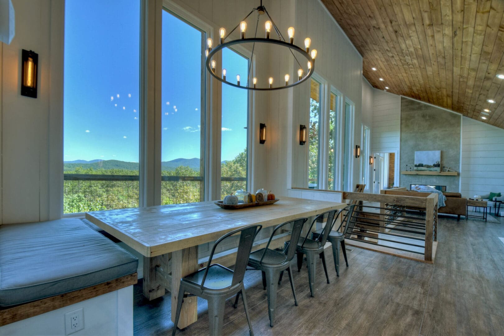A dining room with a large window overlooking the mountains, provided by Architectural Design services.