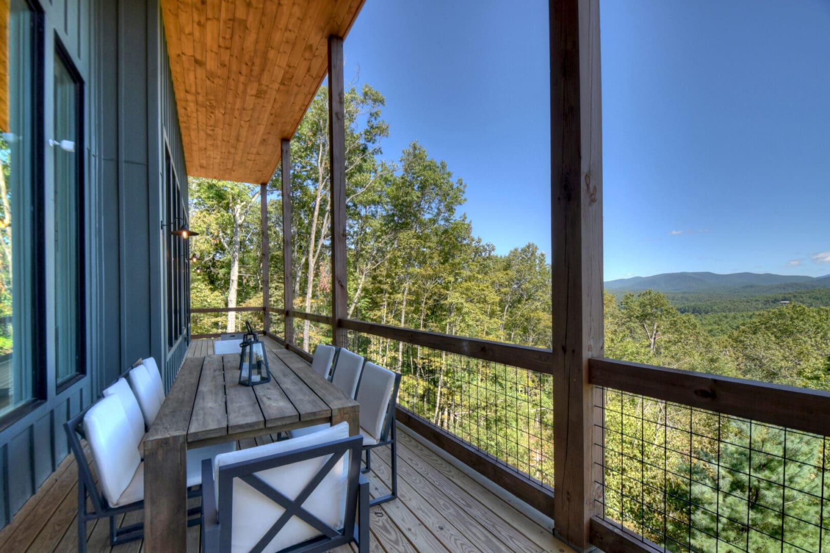 Architectural Design services for a deck with a table and chairs overlooking the mountains.