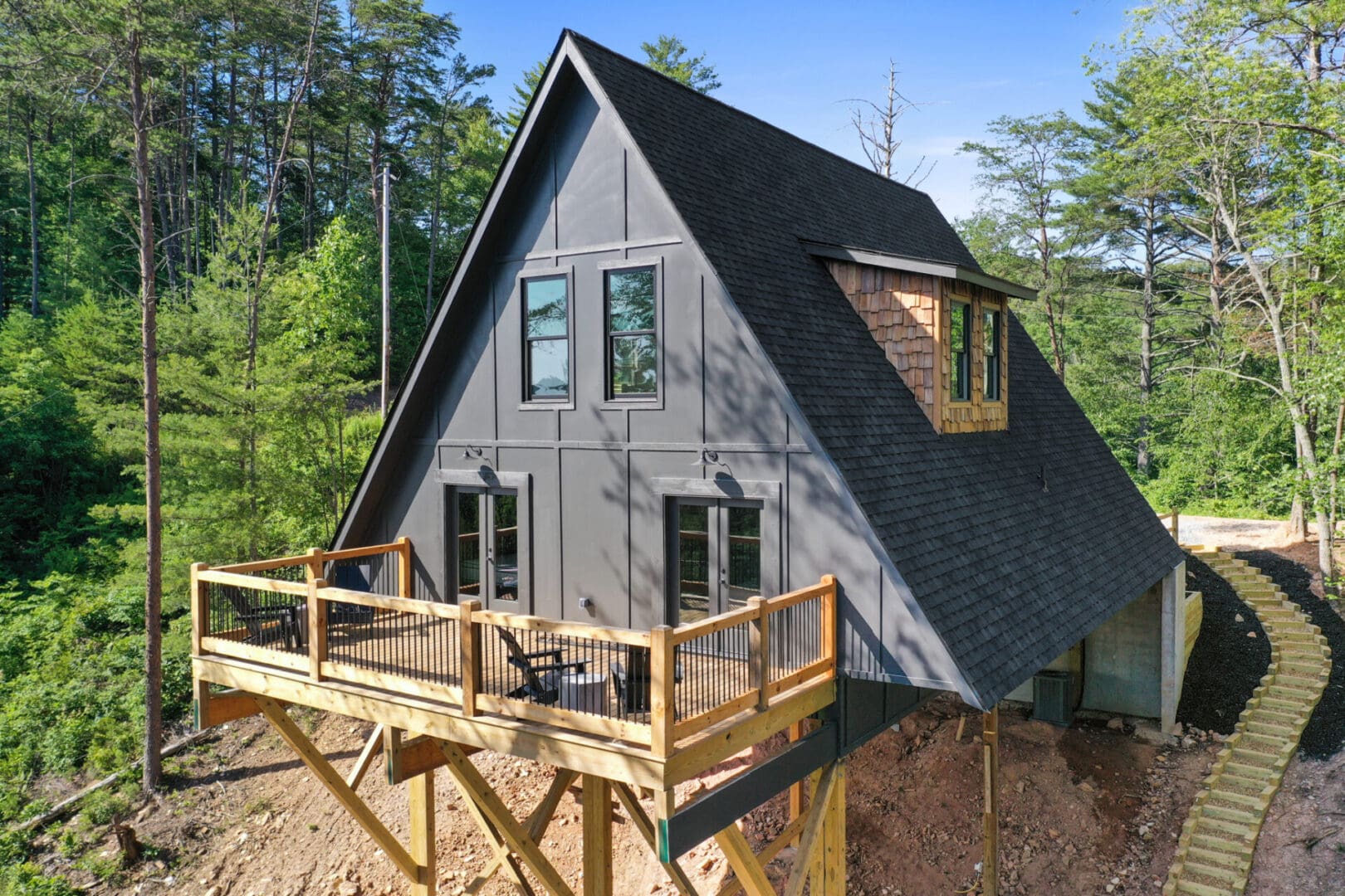 Architectural Design services were employed to create a captivating cabin in the woods, boasting a thoughtful layout complete with a deck and stairs.