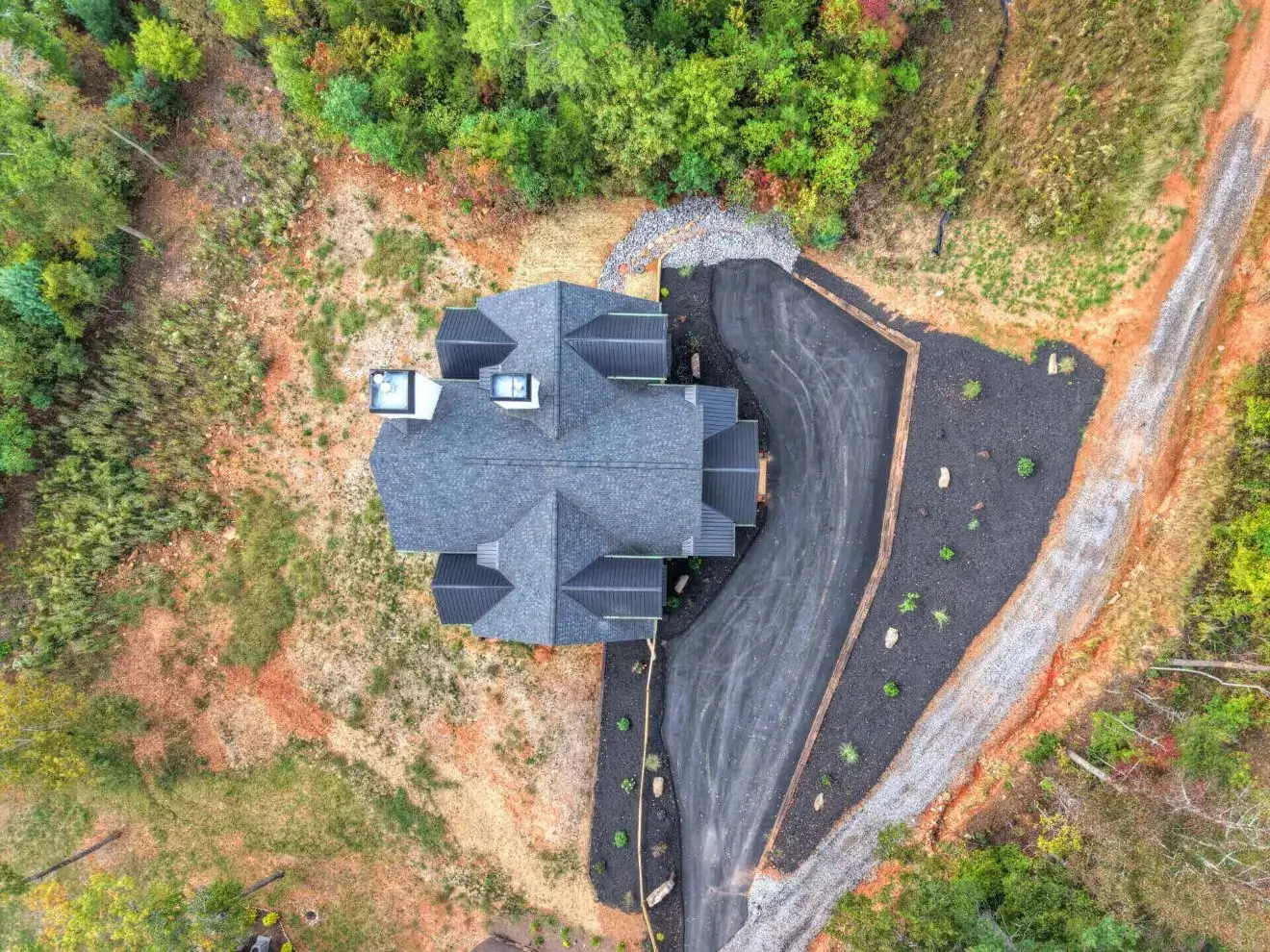 Aerial view of house surrounded by trees.