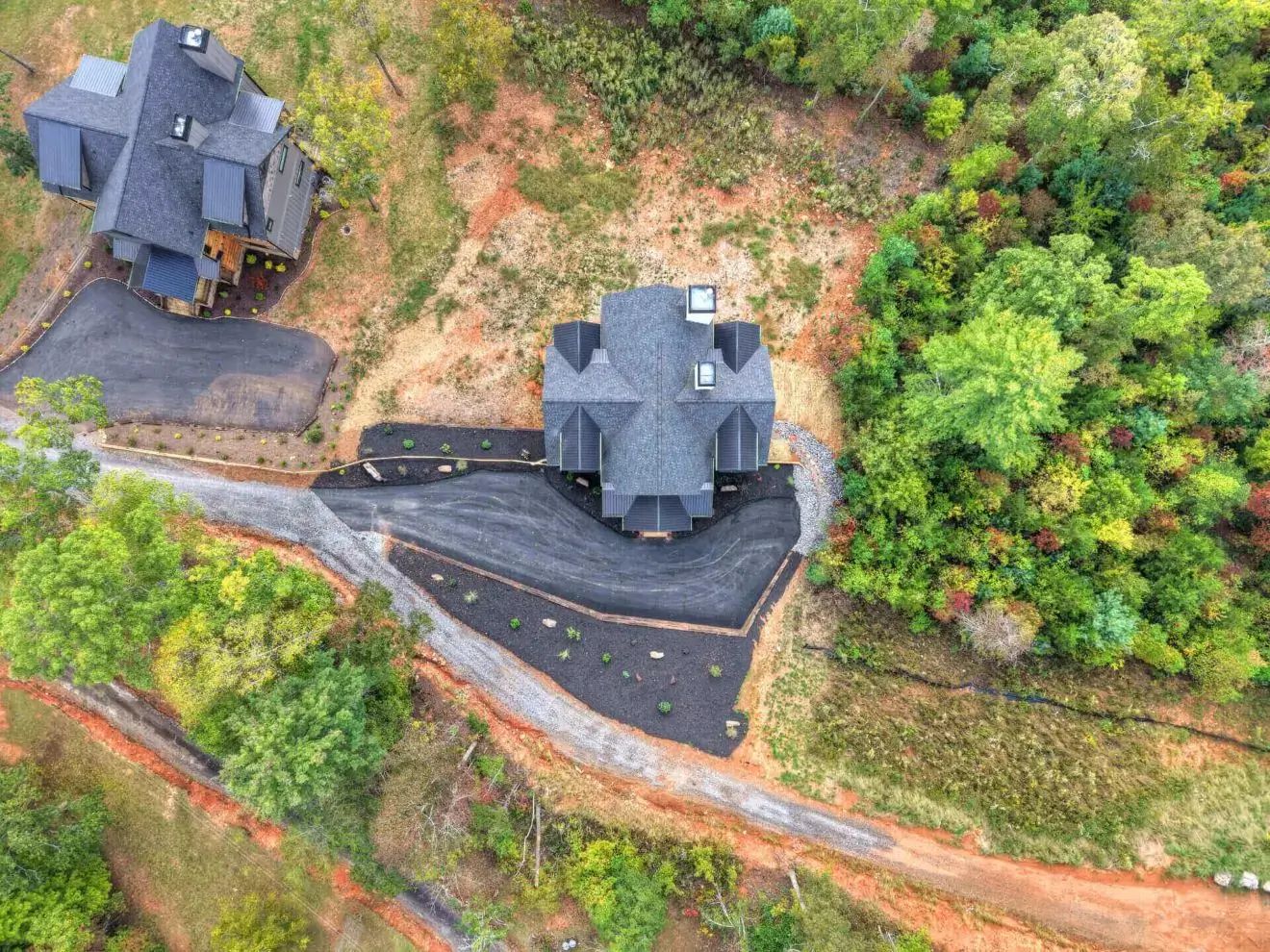 Aerial view of houses and surrounding greenery.